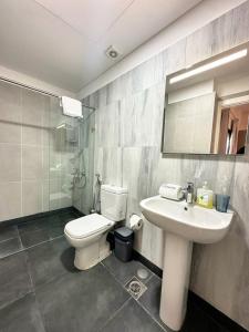 a bathroom with a white toilet and a sink at B-nine Batroun Central | Studio w/ Parking in Batroûn