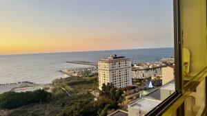 a view of the ocean from a building at Amber – 10th Floor Sea View Studio, Kaslik in Jounieh +4 photos