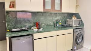a kitchen with a sink and a washing machine at Amber – 10th Floor Sea View Studio, Kaslik in Jounieh