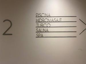 a sign with the names of different languages on a wall at ONE Luxury Suite Super King Bed & Volcano View in Quito