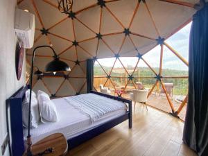 a room with a bed and a large window at Bodrum Dome Suites in Bodrum City