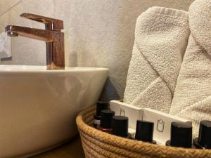a bathroom with a sink and a faucet and towels at Bodrum Dome Suites in Bodrum City