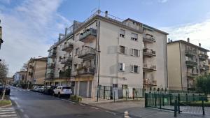 a tall building with cars parked in front of it at Casa di Giada - Venice Gateway - Family Comfort - Free Public Parking& Tram -Link in Mestre