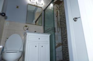 a bathroom with a toilet and a sink and a mirror at New York private room 31 in West New York