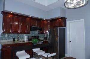 a kitchen with wooden cabinets and a stainless steel refrigerator at New York private room 31 in West New York