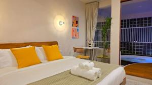 a bedroom with a bed with towels on it at Wanderlust HAUS in Ko Larn