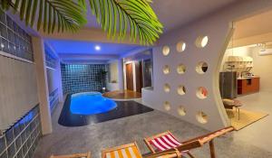 a house with a pool in the middle of a room at Wanderlust HAUS in Ko Larn