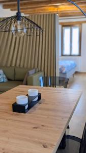 a wooden table with two bowls on top of it at Locanda alla Nave in Pianzano