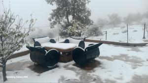 a table covered in snow in a yard at Tigmi Nlkhir in Aït Irizane