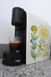 a coffee maker with a cup on top of it at Loreto Apartment in Bragança