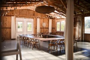 a large wooden table and chairs in a barn at Dom w Przepitkach in Przepitki