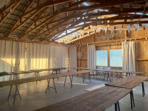 a large room with wooden tables and chairs at Dom w Przepitkach in Przepitki
