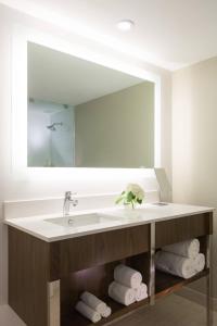 a bathroom with a sink and a large mirror at Renaissance Santo Domingo Jaragua Hotel & Casino in Santo Domingo