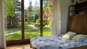 a bedroom with a bed in front of a large window at Dom w Przepitkach in Przepitki +50 photos