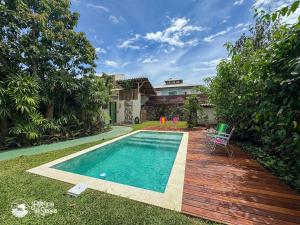 a swimming pool in the backyard of a house at Chalés Canoa in Ilhabela