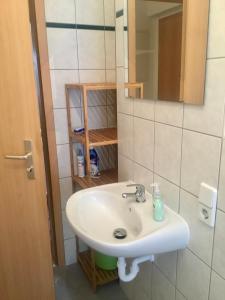 a bathroom with a sink and a mirror at Ferienwohnung Keilbergblick in Kurort Oberwiesenthal +15 photos