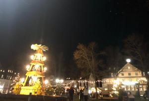 a christmas tree in the middle of a city at night at Ferienwohnung Keilbergblick in Kurort Oberwiesenthal