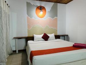 a bedroom with a bed with a painting on the wall at inner pease in Nikawatawana
