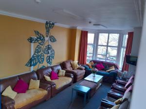 a living room with two couches and a tv at Woodlands Centre in Betws-y-coed