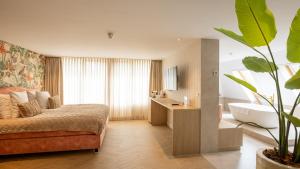 a bedroom with a bed and a tub and a sink at Van der Valk Hotel Assen in Assen +134 photos