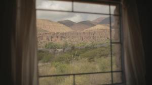 a view of a desert from a window at Macondo - Casas entre cerros in Tilcara