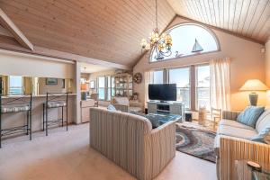 a living room with two couches and a tv at Ocean Song - 2 Bedroom Oceanfront Penthouse Condo in Kill Devil Hills, Spacious Layout in Kill Devil Hills