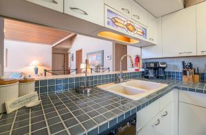 a kitchen with a sink and a counter top at Ocean Song - 2 Bedroom Oceanfront Penthouse Condo in Kill Devil Hills, Spacious Layout in Kill Devil Hills