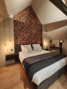a bedroom with a large bed with a wall at Obobonne in Geraardsbergen