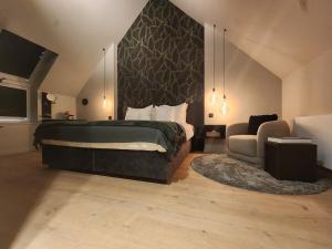 a bedroom with a bed and a couch and a chair at Obobonne in Geraardsbergen +22 photos