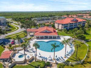 an aerial view of a resort with a pool and palm trees at Bouchelle Island 203 in New Smyrna Beach