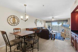 a kitchen and living room with a table and chairs at Bouchelle Island 203 in New Smyrna Beach