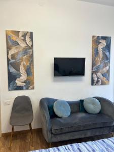 a living room with a couch and a flat screen tv at Comfort Accommodation Room in Bergamo