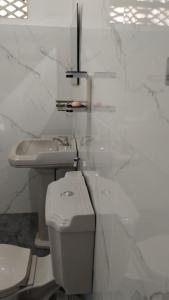 a white bathroom with a toilet and a sink at Oshi villa in Hikkaduwa +34 photos