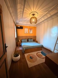 a bedroom with two beds and a chandelier at Julie's AIRPORT Apartment in Marrakesh