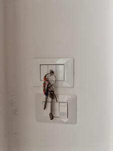 a bunch of keys hanging from a lightswitch at Casa Gada in Torre Lapillo