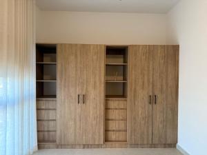 a closet with wooden cabinets in a room at chema in Cabo San Lucas