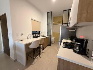 a kitchen with a counter and a kitchen with a stove at chema in Cabo San Lucas