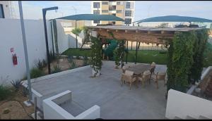 a patio with a table and chairs and umbrellas at chema in Cabo San Lucas