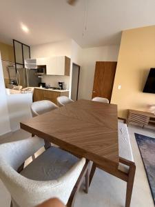 a dining room with a wooden table and chairs at chema in Cabo San Lucas