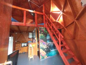 a red staircase in a room with a wall at Domo Premium in Esquina
