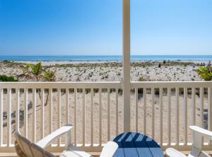 Blick auf den Strand vom Balkon eines Strandhauses in der Unterkunft Drifting Sands Oceanfront Hotel in Ship Bottom