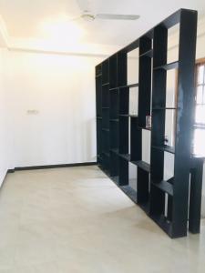 a room with black shelves in a white wall at Blue Deer Villa in Trincomalee