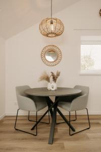 a dining room with a table and two chairs at De Vlaeke in Kerkwerve