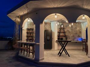a stage with a table and chairs and lights at Hostal Peña de Carlo in Toluca