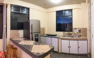a kitchen with a refrigerator and a sink at Hostal Peña de Carlo in Toluca +17 photos