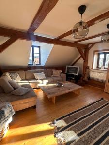 a living room with a couch and a coffee table at Chalupa Svratouch in Svratouch