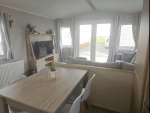 a living room with a table and a couch at Crozzer's Place in Heysham