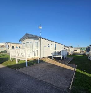 a building with two benches in front of it at Crozzer's Place in Heysham