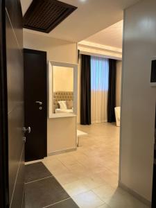 a hotel room with a mirror and a door at Hotel Donna Crescenza in Locorotondo