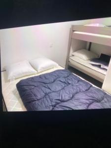 a small bedroom with a bed and a bunk bed gmaxwell gmaxwell gmaxwell at app 8 couchages tt confort 203 in Laveissière